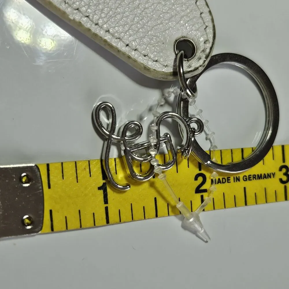 Santa Barbara Design Studio Silver Tone White Leather Tired As A Mother Keychain